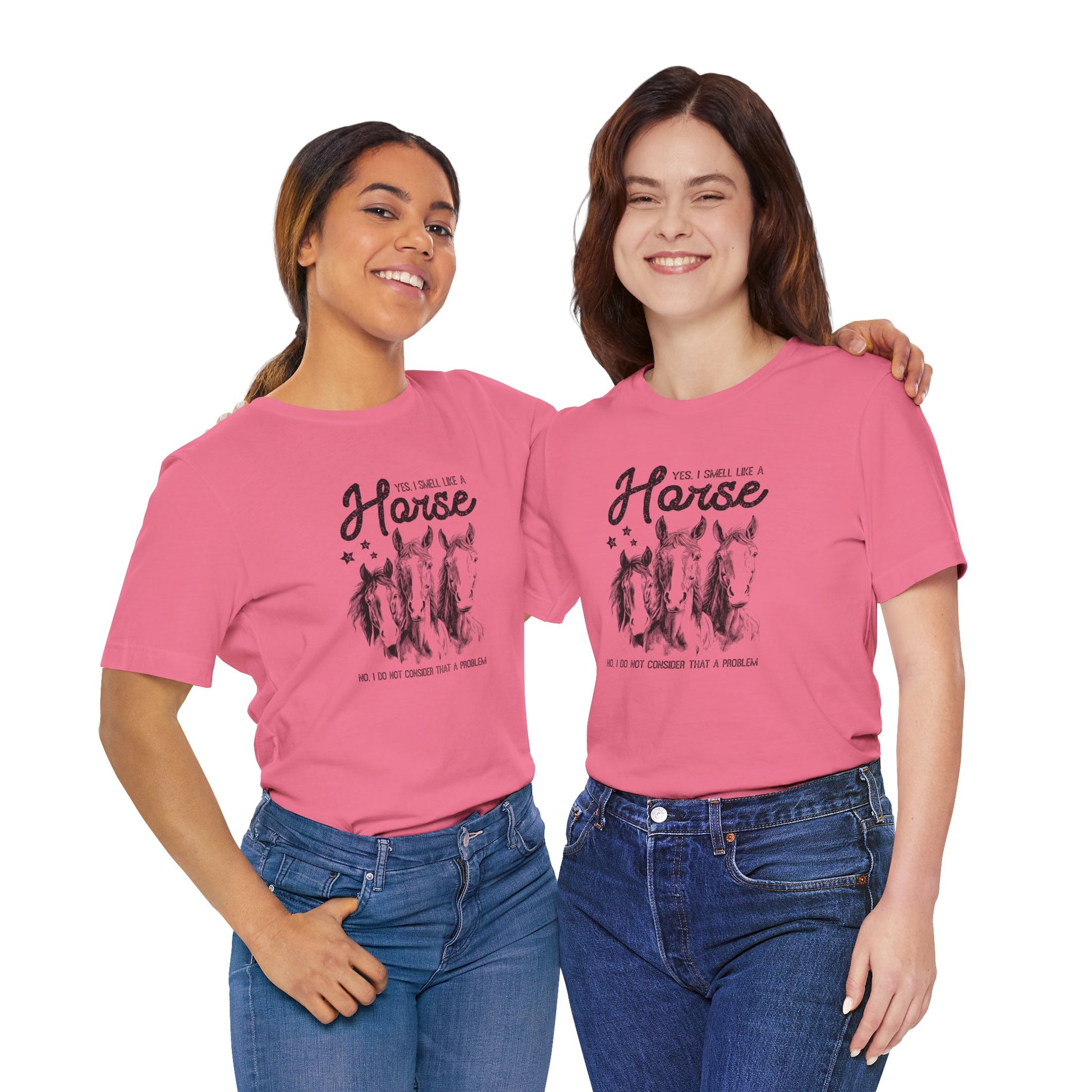 Two women wearing pink t-shirts with a graphic design and text.