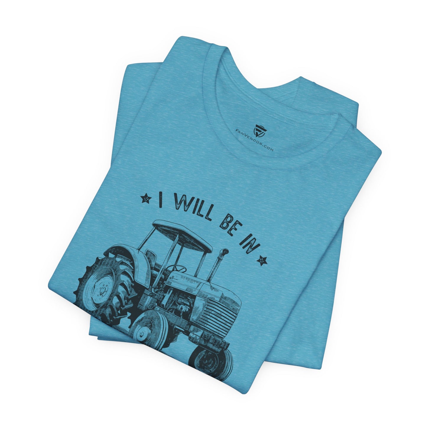 Folded blue t-shirt with tractor graphic and text 