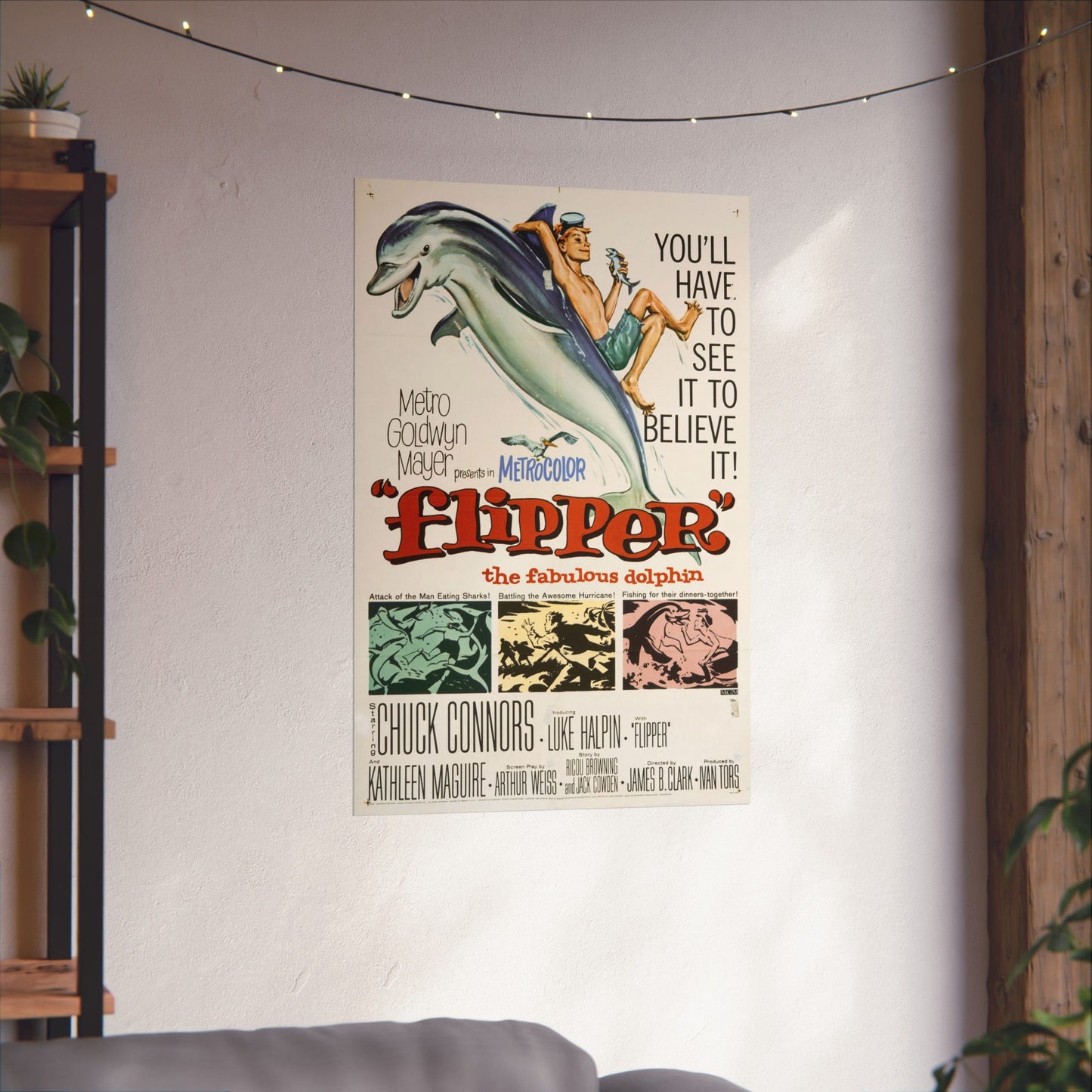 Vintage 'Flipper' movie poster on a wall in a room with plants and a shelf.