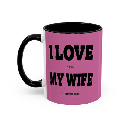 Pink mug with black text and handle on a white background
