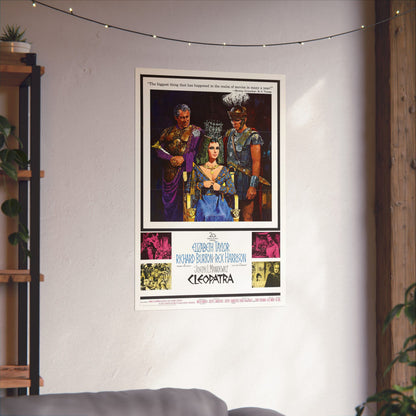 Framed movie poster of 'Cleopatra' on a wall with decorative lights and plants.