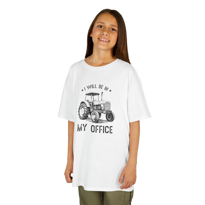 Young girl wearing a white t-shirt with a tractor graphic and text on a white background