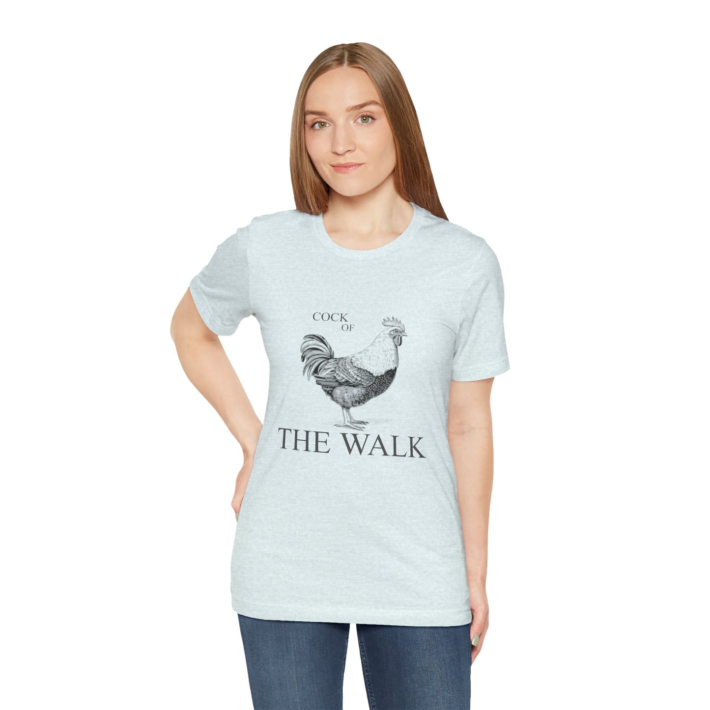 Woman wearing a light blue t-shirt with a rooster graphic and text on a white background