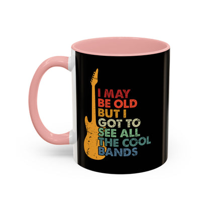 Black mug with pink interior and handle, featuring a colorful guitar graphic and text.