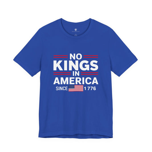 Blue t-shirt with 'No Kings in America Since 1776' text and American flag on a white background