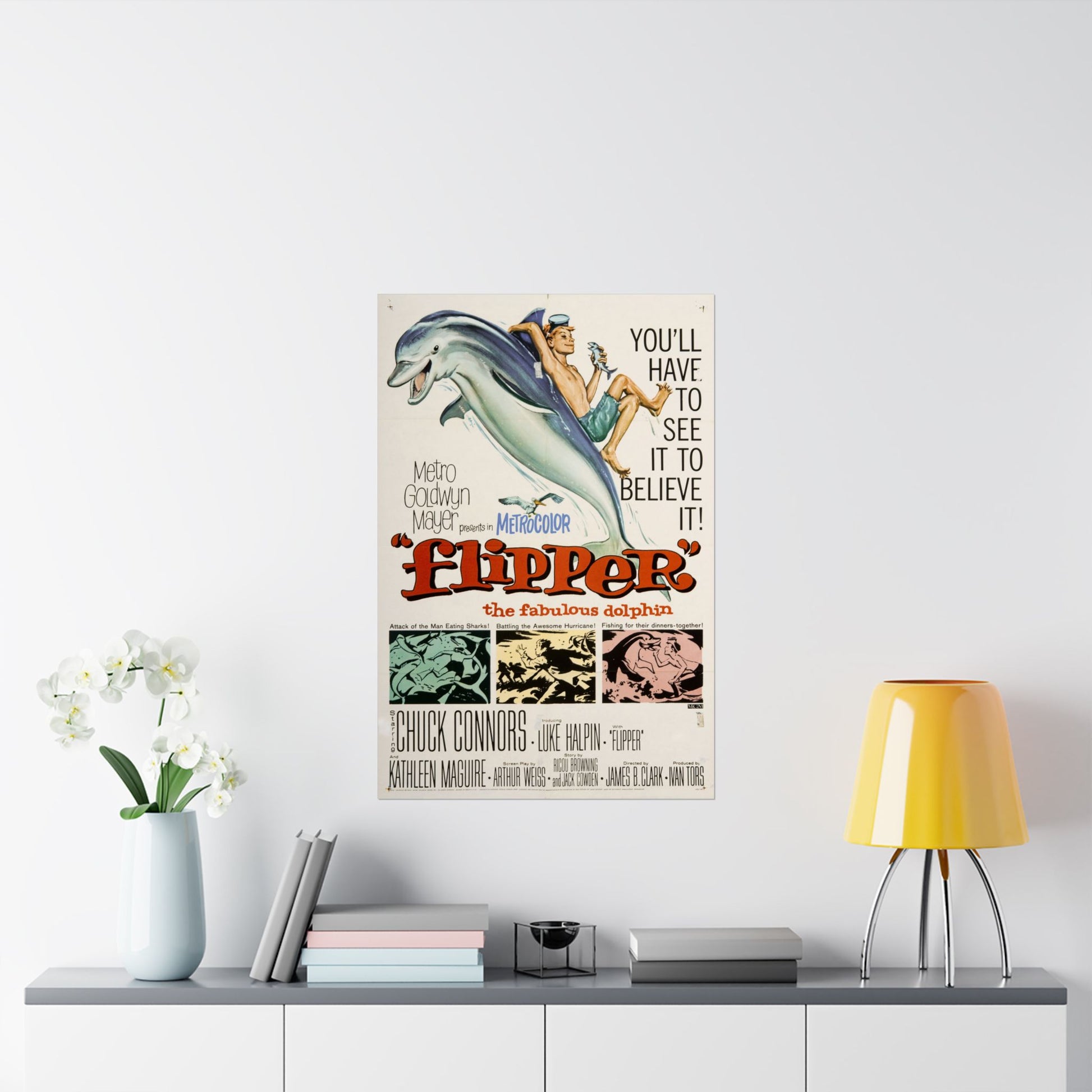 Vintage 'Flipper' movie poster on a wall above a shelf with decor items.